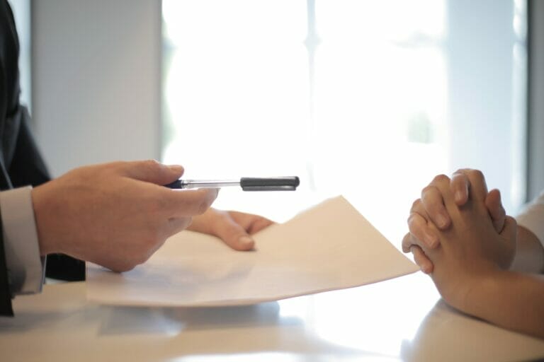 crop businessman giving contract to woman to sign