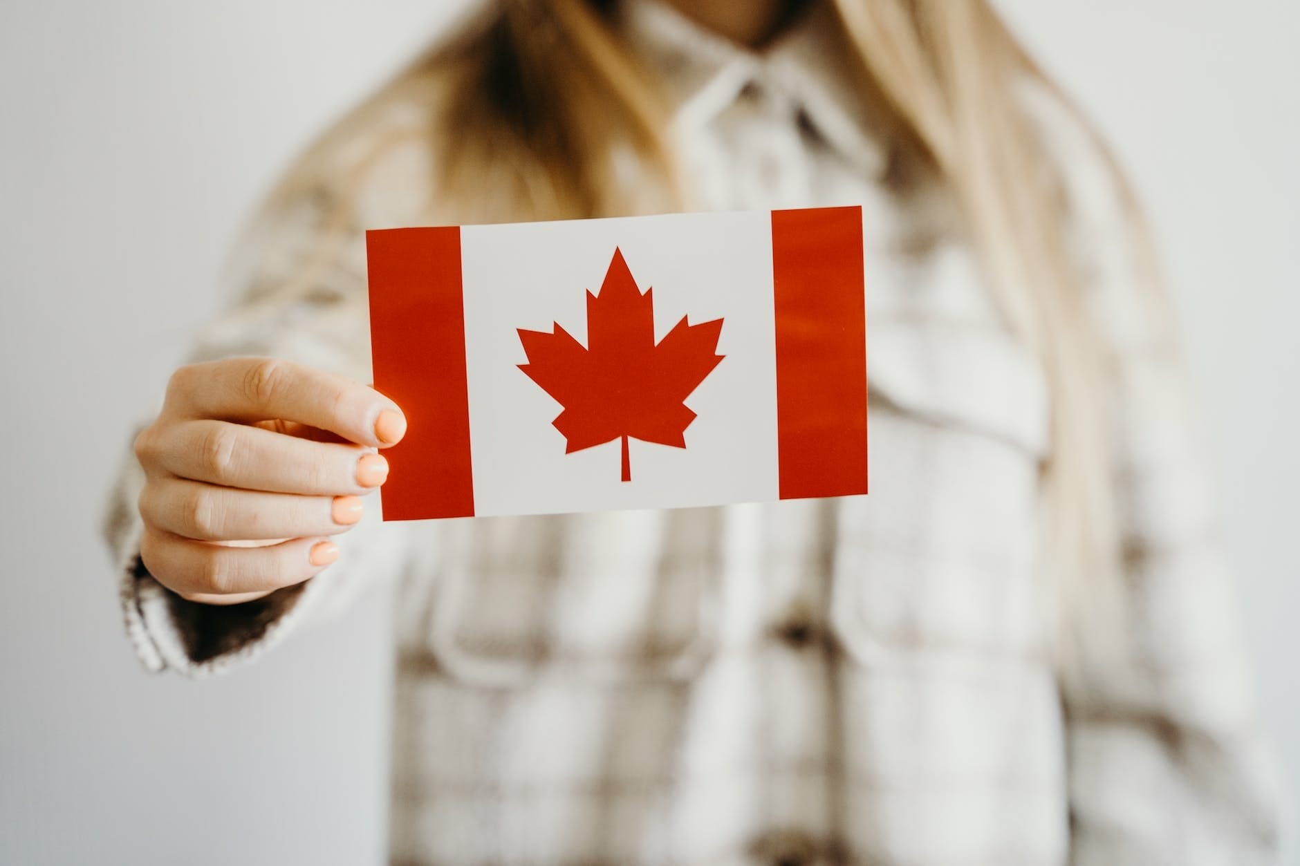 person holding a canadian flag