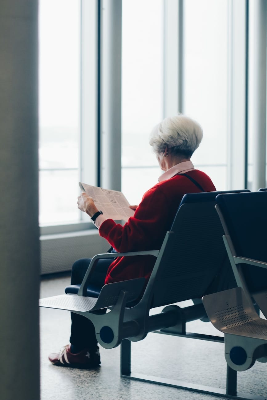 person in red coat sitting on chair